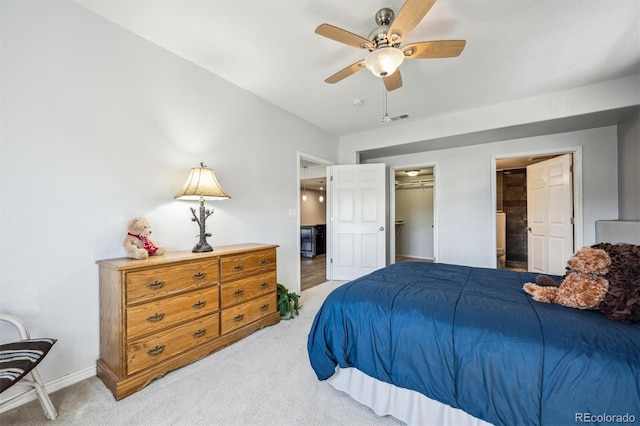 bedroom with light carpet, a closet, baseboards, visible vents, and a spacious closet