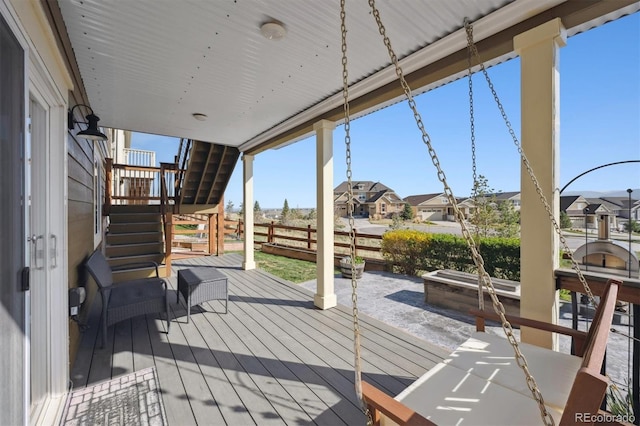 wooden terrace featuring fence private yard, stairs, and a residential view