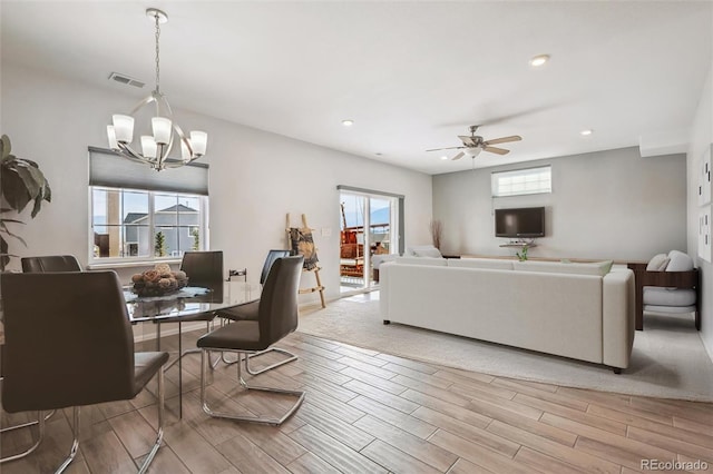 living room featuring recessed lighting, wood finished floors, visible vents, and ceiling fan with notable chandelier