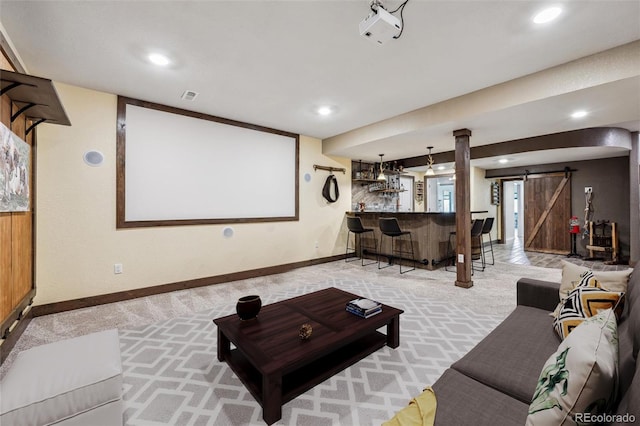 cinema featuring recessed lighting, carpet flooring, a barn door, and wet bar