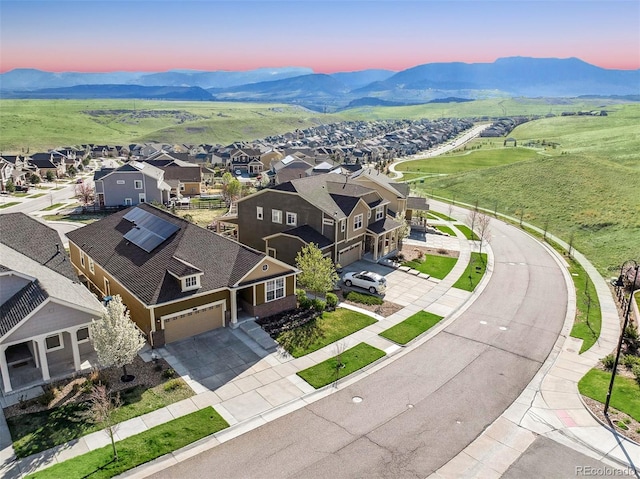 aerial view at dusk with a mountain view and a residential view