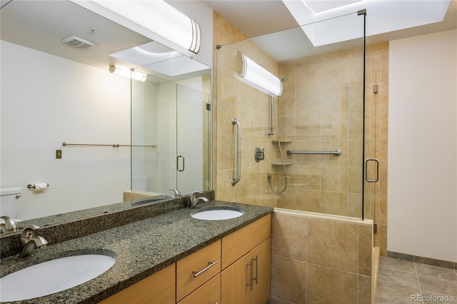 bathroom featuring vanity and a shower with door