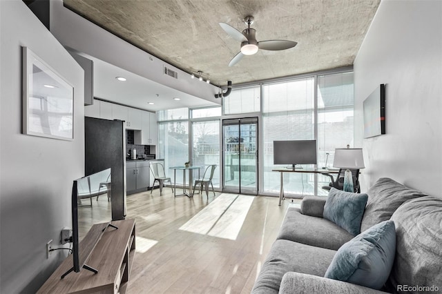 1700 Bassett St Unit 820, Denver, CO 80202 - living area featuring ceiling fan, a wall of windows, and light wood-type flooring