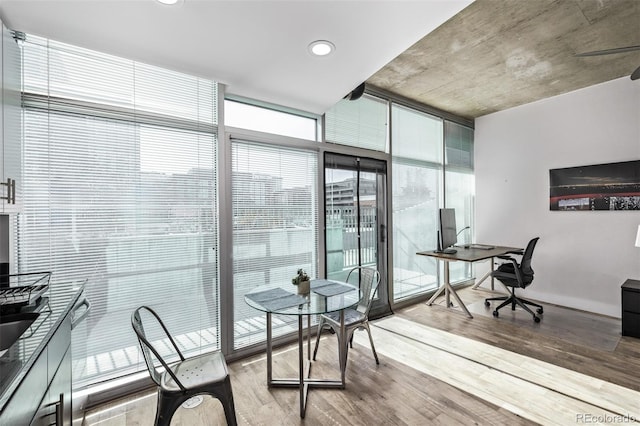 1700 Bassett St Unit 820, Denver, CO 80202 - office area with wood finished floors, baseboards, and a wall of windows