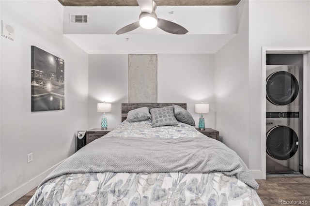 1700 Bassett St Unit 820, Denver, CO 80202 - bedroom with stacked washer and clothes dryer, wood finished floors, baseboards, and ceiling fan