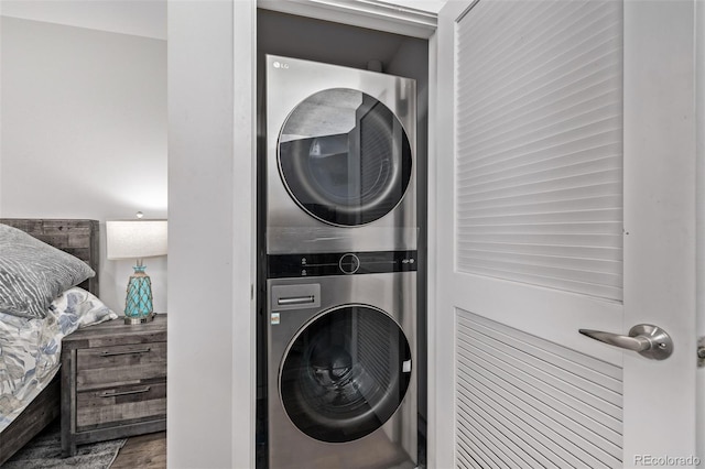 1700 Bassett St Unit 820, Denver, CO 80202 - washroom with stacked washer / dryer and wood finished floors