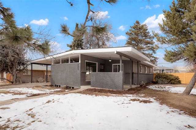 mid-century inspired home with a carport and brick siding