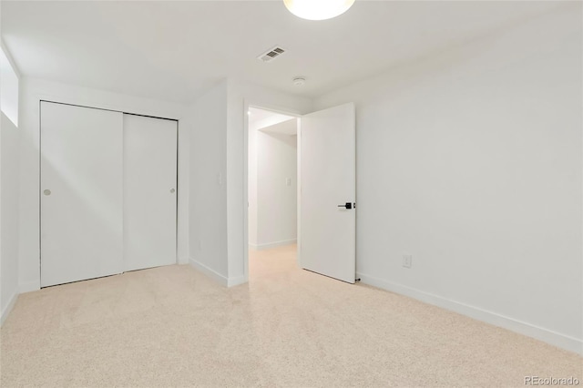 unfurnished bedroom with baseboards, visible vents, and light colored carpet