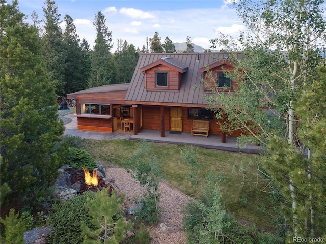 1000 Rangeview Ct, Black Hawk, CO 80422 - back of property featuring a fire pit, a standing seam roof, a metal roof, and covered porch