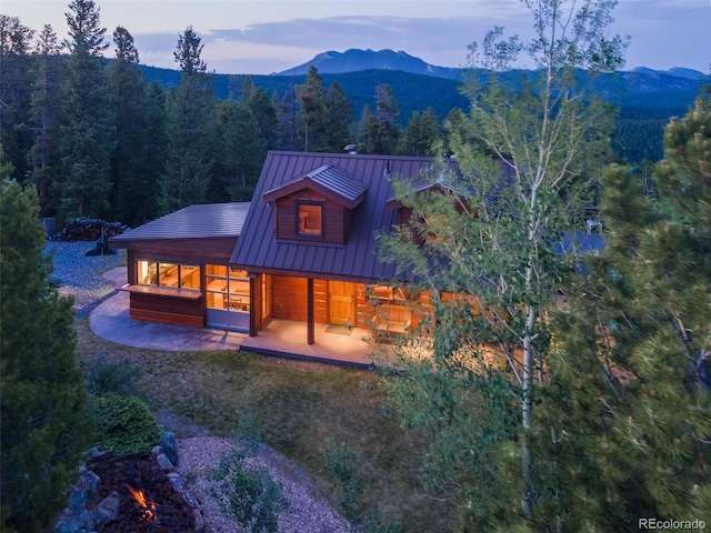 1000 Rangeview Ct, Black Hawk, CO 80422 - back of house featuring a standing seam roof, a wooded view, a metal roof, and a mountain view