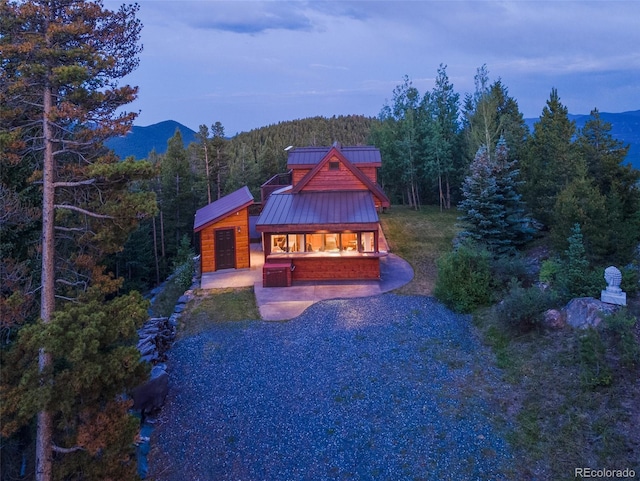 1000 Rangeview Ct, Black Hawk, CO 80422 - view of front of property featuring a wooded view, a standing seam roof, and a mountain view