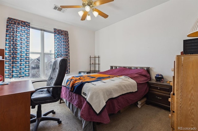 carpeted bedroom featuring visible vents and a ceiling fan