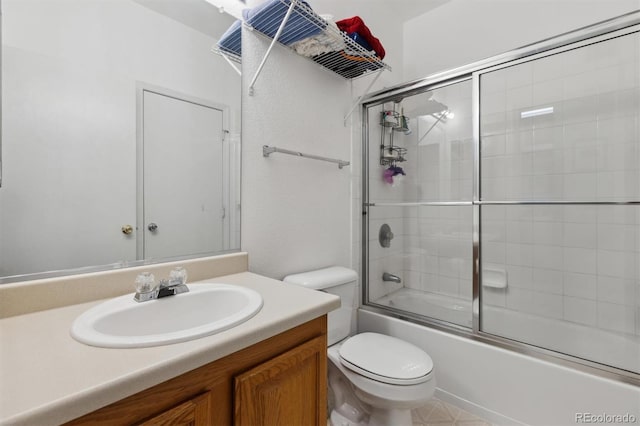 bathroom featuring enclosed tub / shower combo, vanity, and toilet