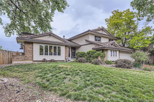 10397 Yates Ct, Westminster, CO 80031 - split level home with a garage, a tiled roof, and brick siding