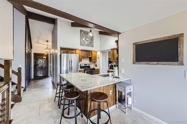10397 Yates Ct, Westminster, CO 80031 - kitchen with appliances with stainless steel finishes, a sink, brown cabinetry, a peninsula, and a kitchen bar