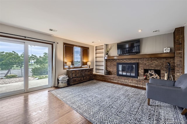 10397 Yates Ct, Westminster, CO 80031 - living room featuring a fireplace, wood finished floors, and built in features
