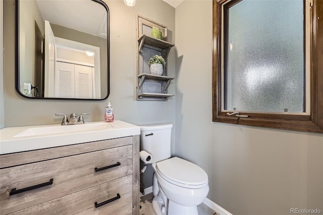 10397 Yates Ct, Westminster, CO 80031 - bathroom with toilet, vanity, and baseboards