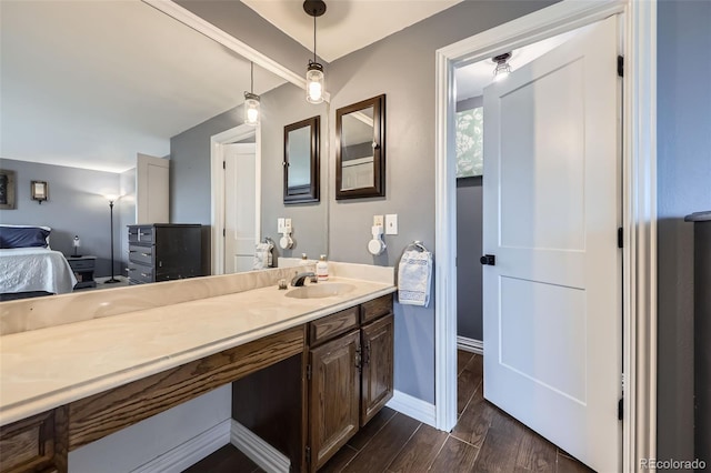 10397 Yates Ct, Westminster, CO 80031 - ensuite bathroom with vanity, wood finished floors, and baseboards