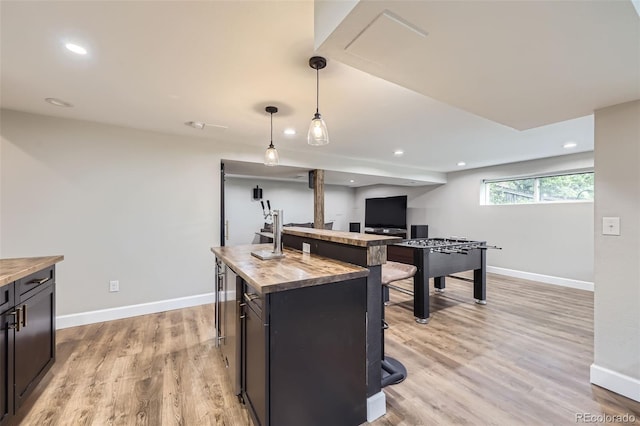 10397 Yates Ct, Westminster, CO 80031 - kitchen with wooden counters, light wood-style flooring, baseboards, pendant lighting, and a center island