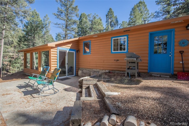 rear view of property featuring a patio area