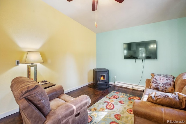 living room featuring a baseboard radiator, a wood stove, dark hardwood / wood-style flooring, ceiling fan, and vaulted ceiling