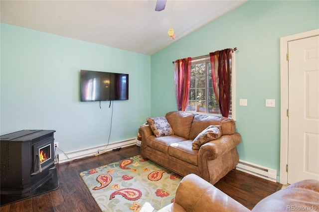 living room with dark wood-type flooring, vaulted ceiling, a wood stove, and a baseboard heating unit