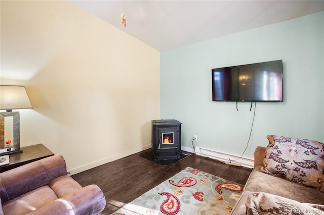 living room featuring a wood stove, hardwood / wood-style flooring, and baseboard heating