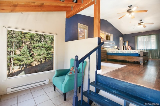 bedroom with vaulted ceiling with beams, light tile patterned floors, baseboard heating, and ceiling fan