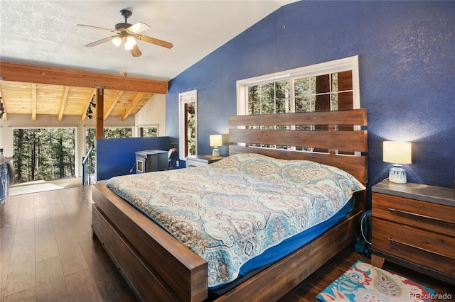 bedroom featuring vaulted ceiling with beams, multiple windows, dark wood-type flooring, and ceiling fan