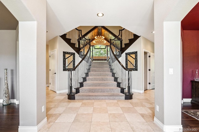 9065 E Lost Hill Trl, Lone Tree, CO 80124 - stairs with a chandelier and baseboards