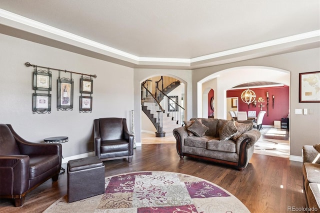 9065 E Lost Hill Trl, Lone Tree, CO 80124 - living area with arched walkways, stairway, wood finished floors, ornamental molding, and a chandelier