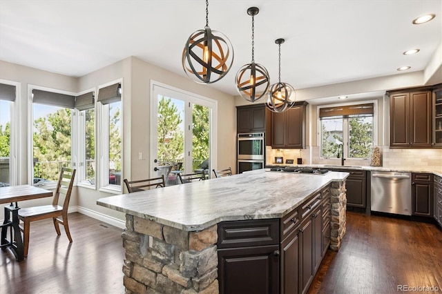 9065 E Lost Hill Trl, Lone Tree, CO 80124 - kitchen featuring appliances with stainless steel finishes, a chandelier, plenty of natural light, dark wood-style floors, and recessed lighting