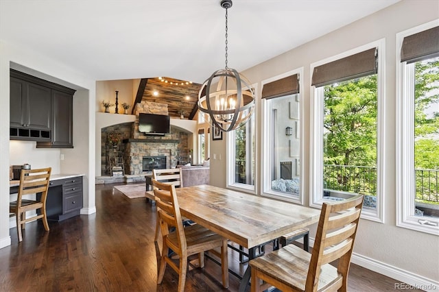 9065 E Lost Hill Trl, Lone Tree, CO 80124 - dining area with healthy amount of natural light, a chandelier, dark wood-style flooring, and a fireplace