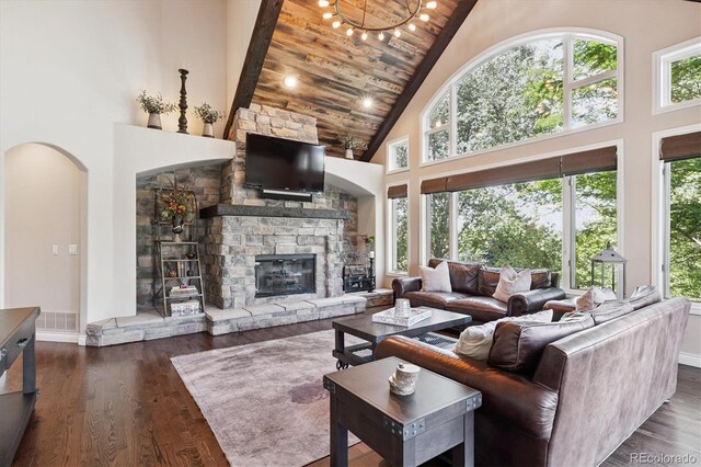 9065 E Lost Hill Trl, Lone Tree, CO 80124 - living room with high vaulted ceiling, a fireplace, arched walkways, wood finished floors, and wooden ceiling