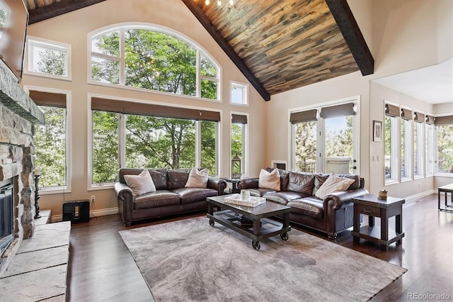 9065 E Lost Hill Trl, Lone Tree, CO 80124 - living room with high vaulted ceiling, a stone fireplace, healthy amount of natural light, wooden ceiling, and wood finished floors
