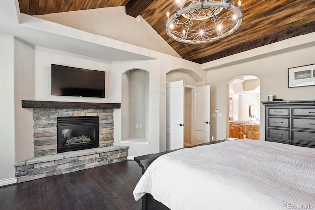 9065 E Lost Hill Trl, Lone Tree, CO 80124 - bedroom with a chandelier, wood finished floors, beam ceiling, a stone fireplace, and high vaulted ceiling