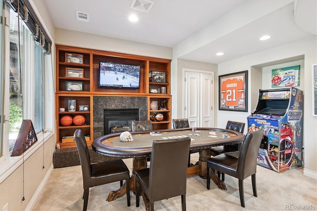 9065 E Lost Hill Trl, Lone Tree, CO 80124 - dining room featuring a glass covered fireplace, light colored carpet, and recessed lighting