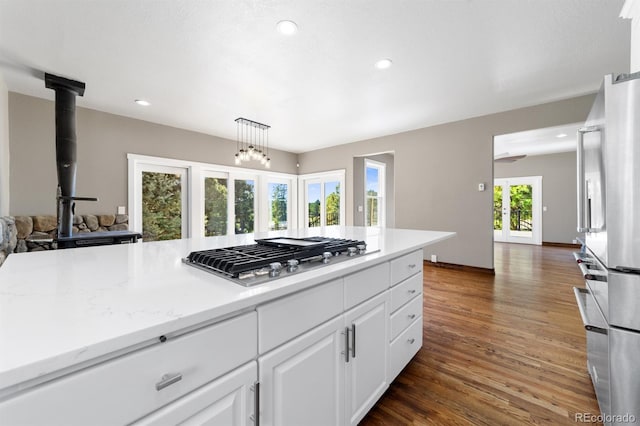 kitchen featuring a wealth of natural light, pendant lighting, dark hardwood / wood-style flooring, and appliances with stainless steel finishes