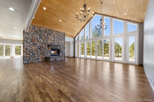 unfurnished living room with a fireplace, high vaulted ceiling, dark wood-type flooring, wooden ceiling, and an inviting chandelier