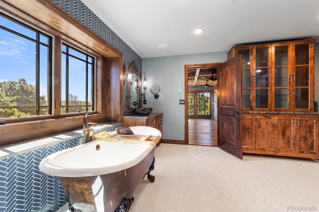 bathroom featuring wood-type flooring and a tub