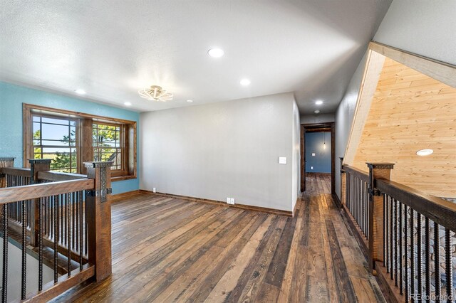 interior space featuring wooden walls and dark hardwood / wood-style floors