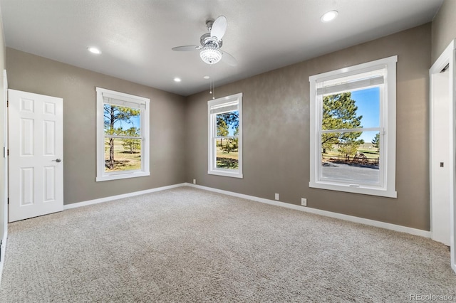 carpeted spare room with ceiling fan