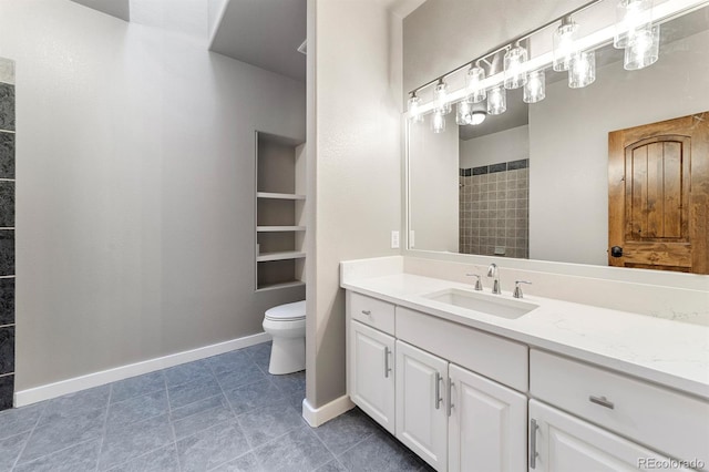 bathroom with tile flooring, vanity, and toilet