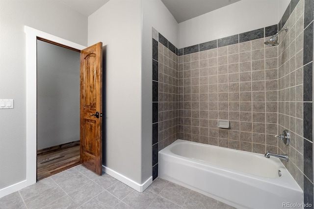 bathroom featuring tiled shower / bath combo and tile floors