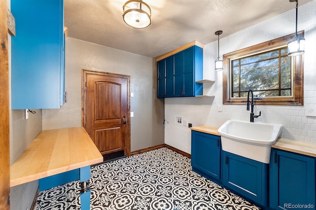 bathroom featuring tile flooring, vanity, tile walls, and a textured ceiling