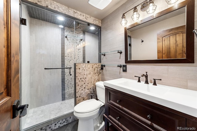 bathroom with walk in shower, oversized vanity, tile walls, and toilet