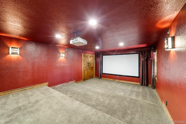 carpeted home theater room featuring a textured ceiling