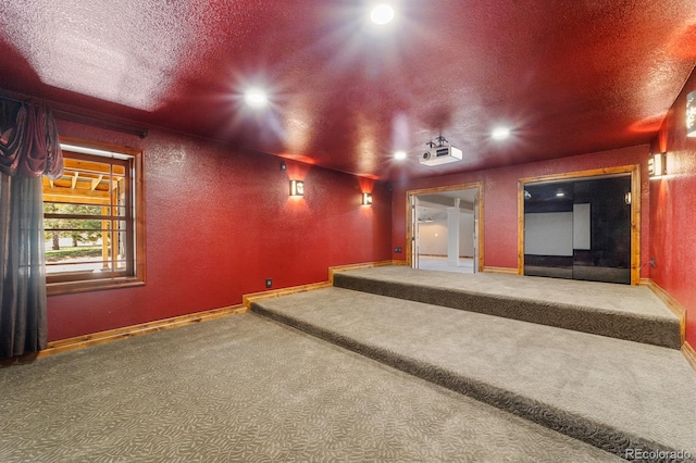 carpeted cinema room with a textured ceiling