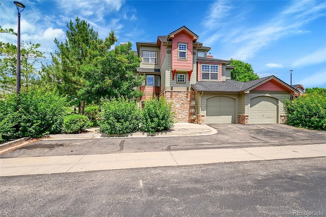 5220 Boardwalk Dr Unit A14, Fort Collins, CO 80525 - townhome / multi-family property featuring stone siding, asphalt driveway, and a garage