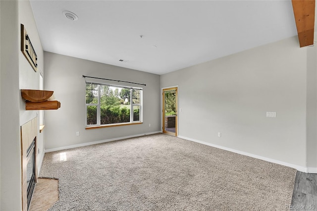5220 Boardwalk Dr Unit A14, Fort Collins, CO 80525 - unfurnished living room with a tile fireplace and light colored carpet